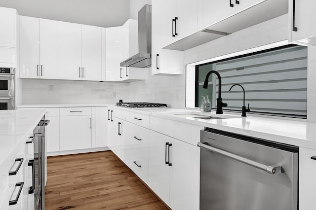 1505 Stuart St, Houston, TX 77004 - kitchen featuring wall chimney exhaust hood, stainless steel appliances, a sink, and tasteful backsplash