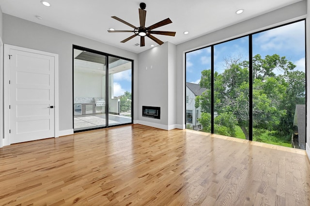 1505 Stuart St, Houston, TX 77004 - unfurnished living room featuring wood finished floors, ceiling fan, healthy amount of natural light, baseboards, and recessed lighting