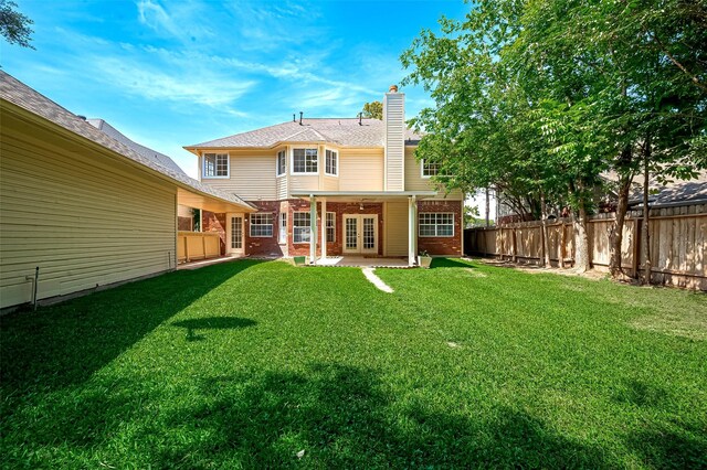 2130 Avenida La Quinta St, Houston, TX 77077 - back of house featuring brick siding, french doors, a patio area, and a chimney