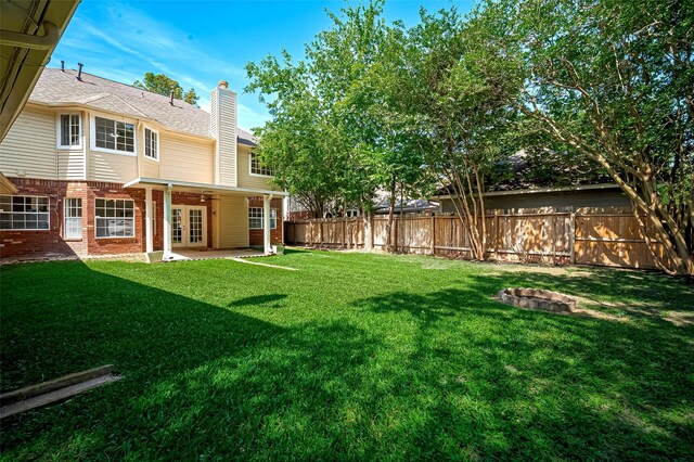 2130 Avenida La Quinta St, Houston, TX 77077 - view of yard with french doors and a patio