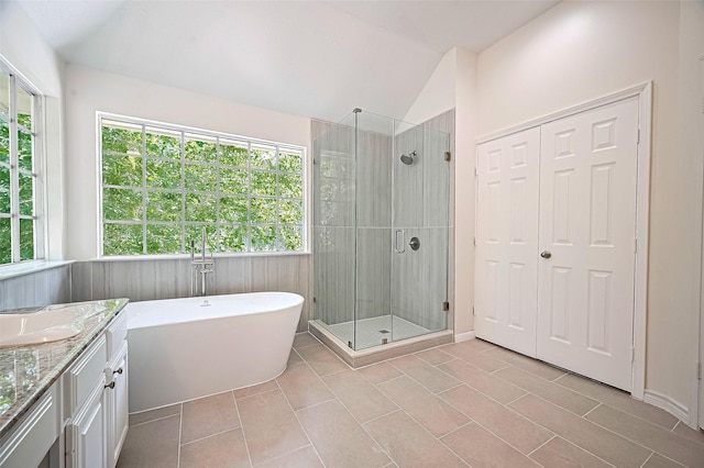 2130 Avenida La Quinta St, Houston, TX 77077 - bathroom featuring a stall shower, a freestanding bath, vanity, tile patterned flooring, and vaulted ceiling