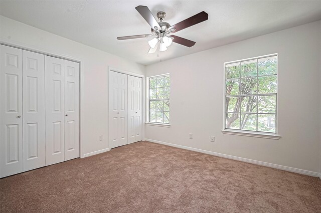 2130 Avenida La Quinta St, Houston, TX 77077 - unfurnished bedroom featuring multiple closets, carpet floors, baseboards, and a ceiling fan