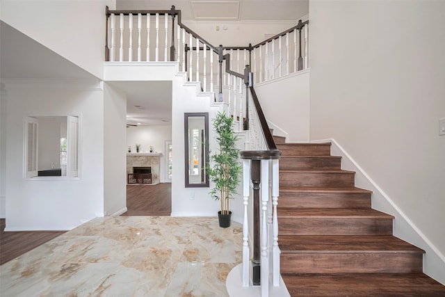 2130 Avenida La Quinta St, Houston, TX 77077 - stairs with a high ceiling, wood finished floors, a fireplace, and baseboards