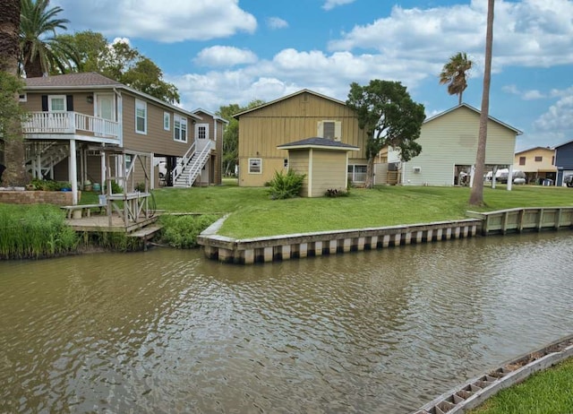 5216 County Road 469 Unit 10, Brazoria, TX 77422 - dock with stairway, a deck with water view, and a lawn
