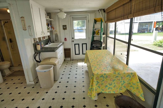 5216 County Road 469 Unit 10, Brazoria, TX 77422 - kitchen featuring light flooring, a sink, and white cabinets