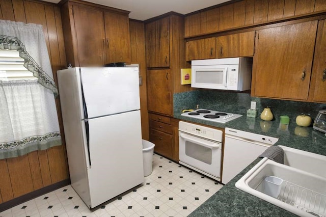 5216 County Road 469 Unit 10, Brazoria, TX 77422 - kitchen featuring white appliances, light flooring, and dark countertops