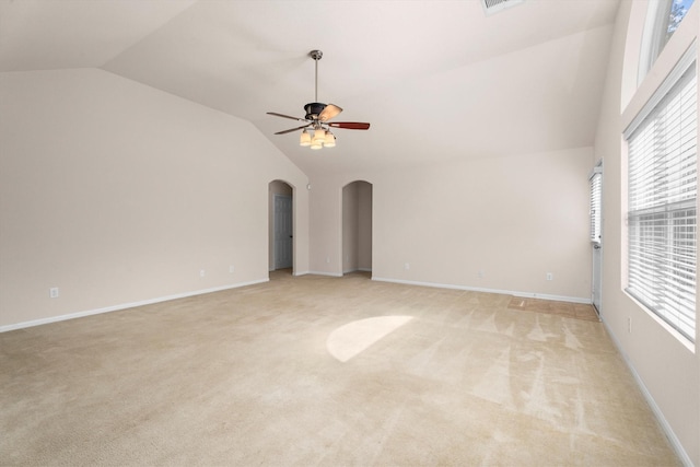 11410 Dahlia Dale Dr, Tomball, TX 77375 - spare room with lofted ceiling, arched walkways, ceiling fan, light colored carpet, and healthy amount of natural light