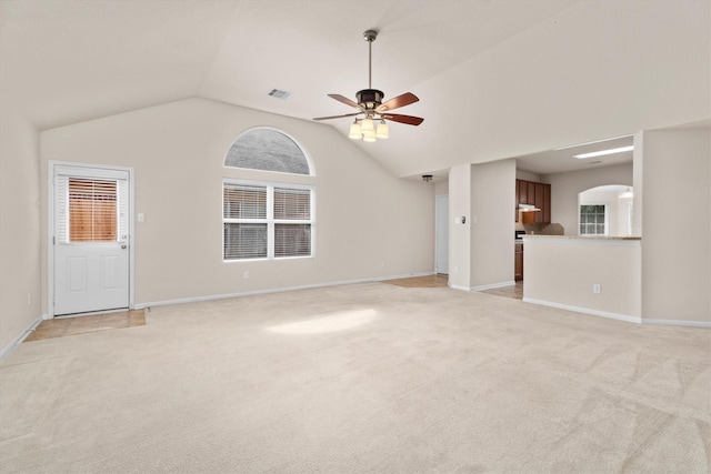 11410 Dahlia Dale Dr, Tomball, TX 77375 - unfurnished living room featuring arched walkways, ceiling fan, light colored carpet, and lofted ceiling