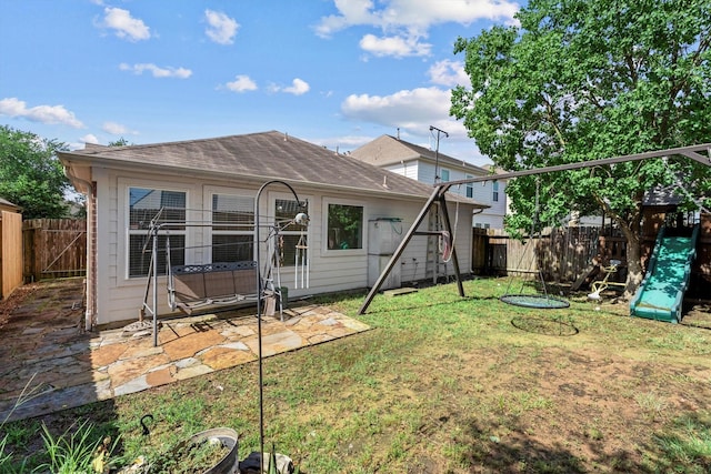 11410 Dahlia Dale Dr, Tomball, TX 77375 - back of house featuring a patio, a shingled roof, and a playground