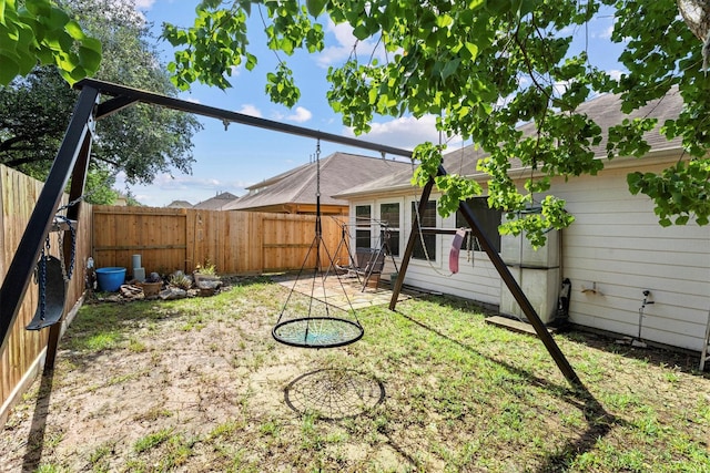 11410 Dahlia Dale Dr, Tomball, TX 77375 - rear view of house with a fenced backyard, a patio area, and a shingled roof