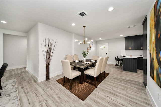 3630 Alsace St, Houston, TX 77021 - dining space with light wood-style flooring, a chandelier, recessed lighting, and baseboards