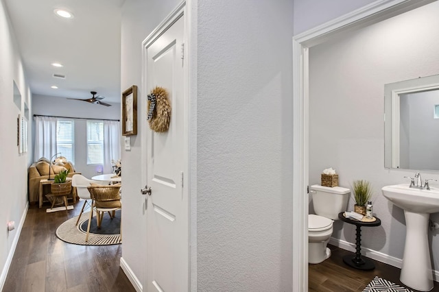 18823 Luminescent Ln, Spring, TX 77379 - hall featuring dark wood-style floors, baseboards, recessed lighting, a textured wall, and a sink