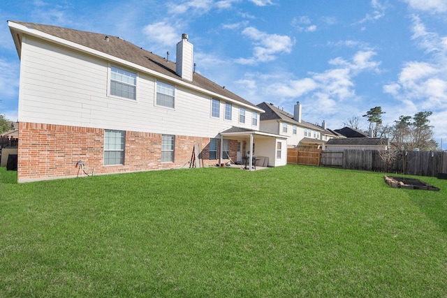 6723 Stableton Ln, Houston, TX 77049 - rear view of property featuring a chimney, brick siding, and a patio area