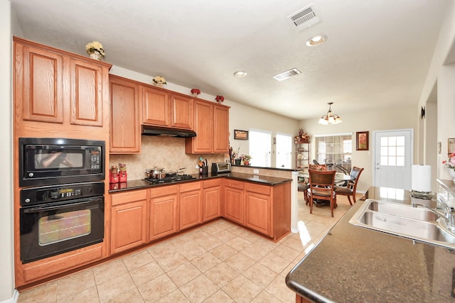 6723 Stableton Ln, Houston, TX 77049 - kitchen featuring black appliances, a chandelier, a peninsula, a sink, and plenty of natural light