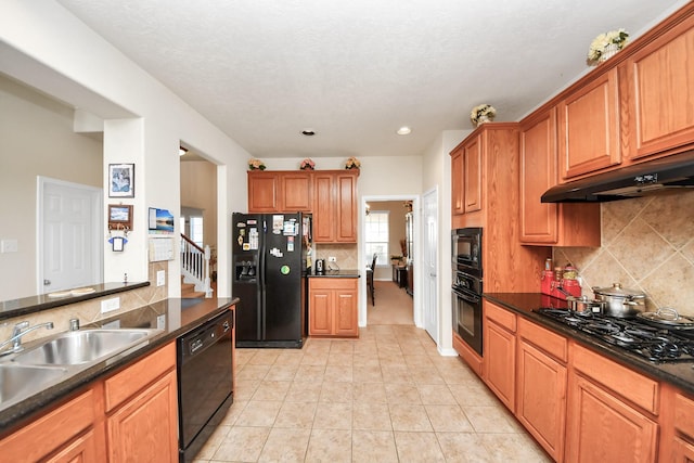 6723 Stableton Ln, Houston, TX 77049 - kitchen with black appliances, dark countertops, decorative backsplash, under cabinet range hood, and brown cabinets