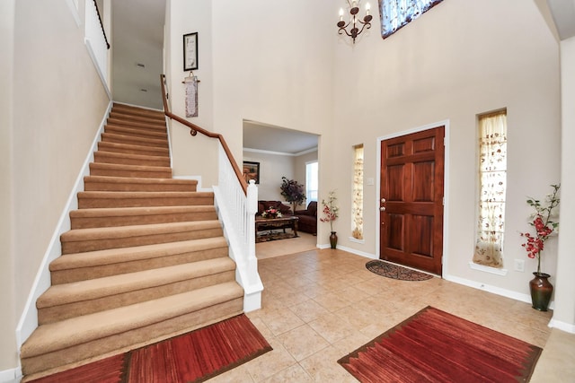 6723 Stableton Ln, Houston, TX 77049 - tiled entrance foyer with stairway, a high ceiling, a chandelier, and baseboards