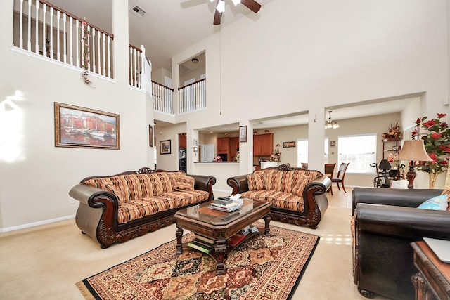 6723 Stableton Ln, Houston, TX 77049 - living area featuring a ceiling fan, a high ceiling, light carpet, and a chandelier