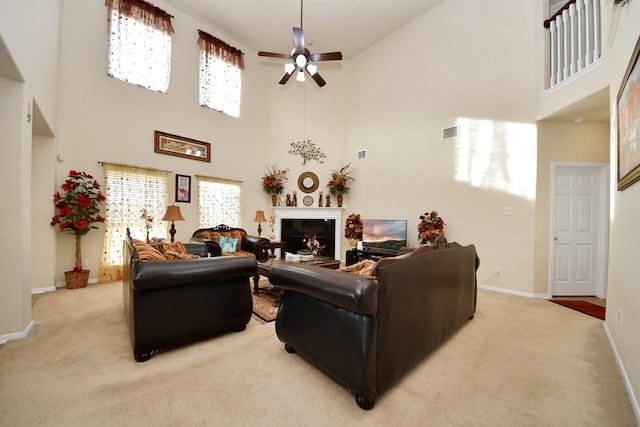 6723 Stableton Ln, Houston, TX 77049 - living room featuring a high ceiling, light colored carpet, baseboards, a ceiling fan, and plenty of natural light