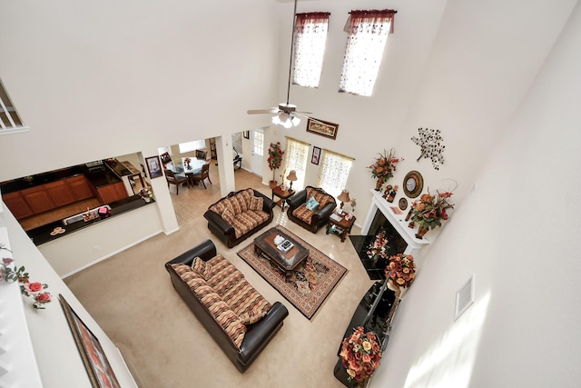 6723 Stableton Ln, Houston, TX 77049 - living room with a towering ceiling, healthy amount of natural light, a ceiling fan, and stairs