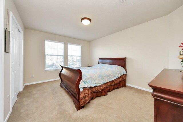 6723 Stableton Ln, Houston, TX 77049 - bedroom with light carpet, baseboards, and a closet