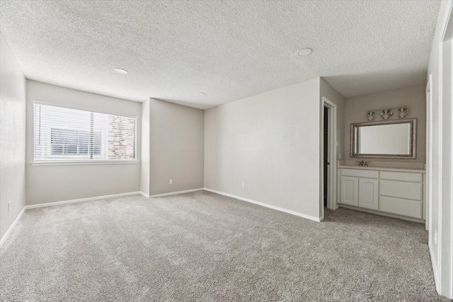 3754 Tanglewilde St N Unit C3, Houston, TX 77063 - unfurnished bedroom featuring carpet flooring, baseboards, a textured ceiling, and a sink
