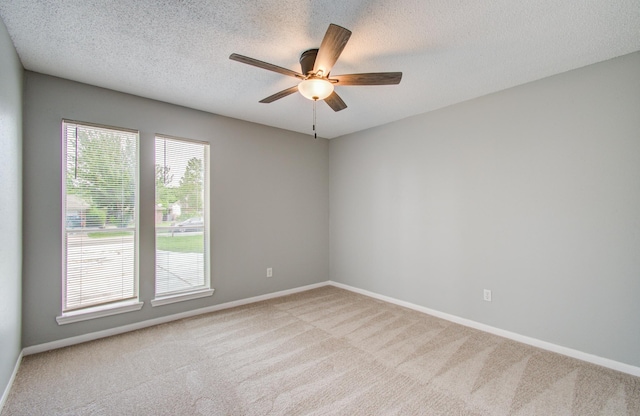 13215 Bunker Hill Dr, Willis, TX 77318 - empty room featuring light carpet, a ceiling fan, baseboards, and a textured ceiling