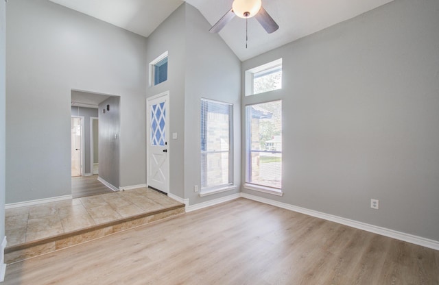 13215 Bunker Hill Dr, Willis, TX 77318 - foyer with high vaulted ceiling, a ceiling fan, baseboards, and wood finished floors