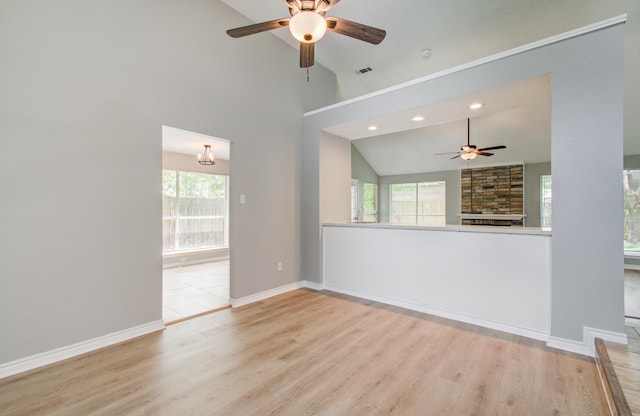 13215 Bunker Hill Dr, Willis, TX 77318 - unfurnished living room featuring ceiling fan, lofted ceiling, a fireplace, wood finished floors, and recessed lighting