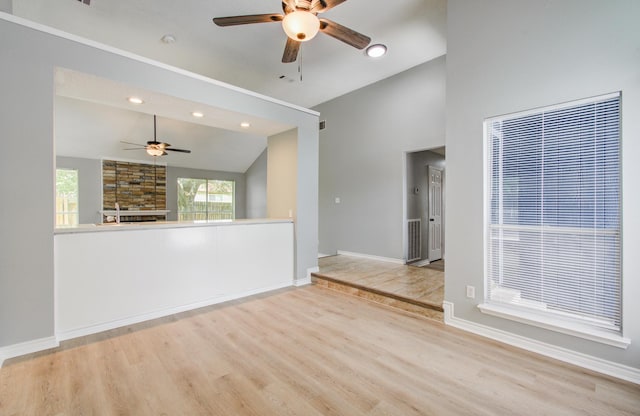 13215 Bunker Hill Dr, Willis, TX 77318 - spare room featuring a ceiling fan, lofted ceiling, wood finished floors, baseboards, and a fireplace