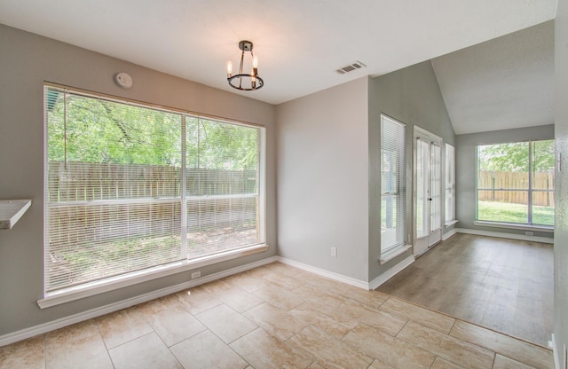 13215 Bunker Hill Dr, Willis, TX 77318 - unfurnished dining area with a chandelier, baseboards, and vaulted ceiling