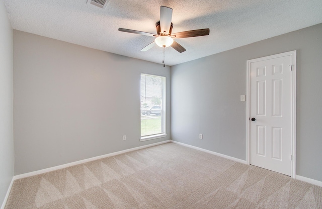 13215 Bunker Hill Dr, Willis, TX 77318 - spare room featuring carpet, ceiling fan, a textured ceiling, and baseboards