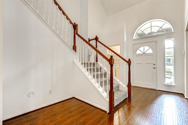 17935 Western Pass Ln, Houston, TX 77095 - foyer entrance featuring hardwood / wood-style flooring, stairway, a high ceiling, and baseboards