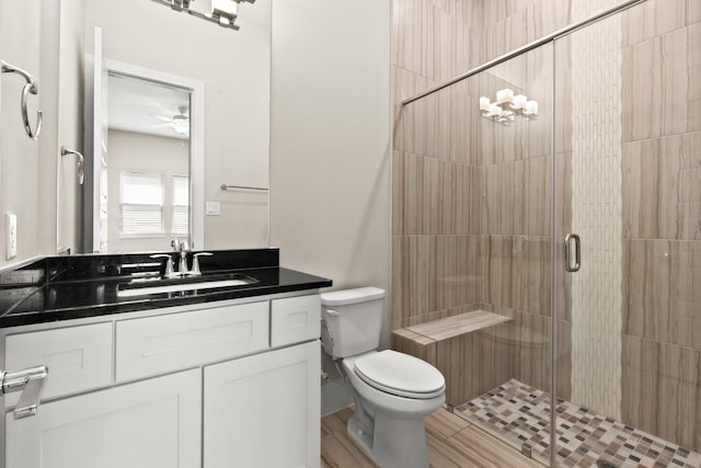 2653 Fountain Key Blvd, Houston, TX 77008 - bathroom featuring toilet, a shower stall, vanity, ceiling fan, and wood finished floors