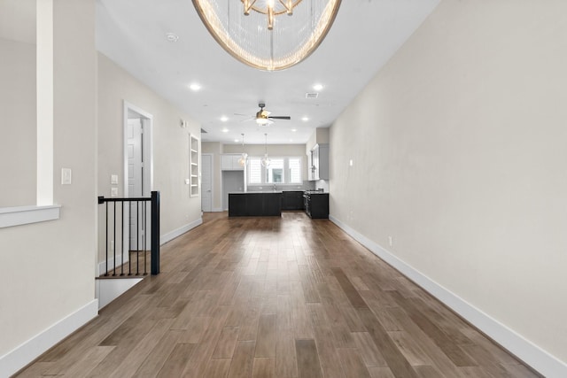 2653 Fountain Key Blvd, Houston, TX 77008 - unfurnished living room featuring wood finished floors, a chandelier, baseboards, recessed lighting, and ceiling fan