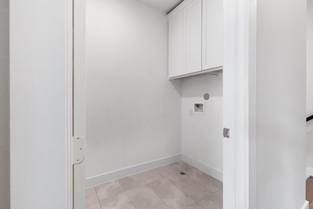 2653 Fountain Key Blvd, Houston, TX 77008 - laundry room featuring cabinet space, hookup for a washing machine, light tile patterned floors, and baseboards