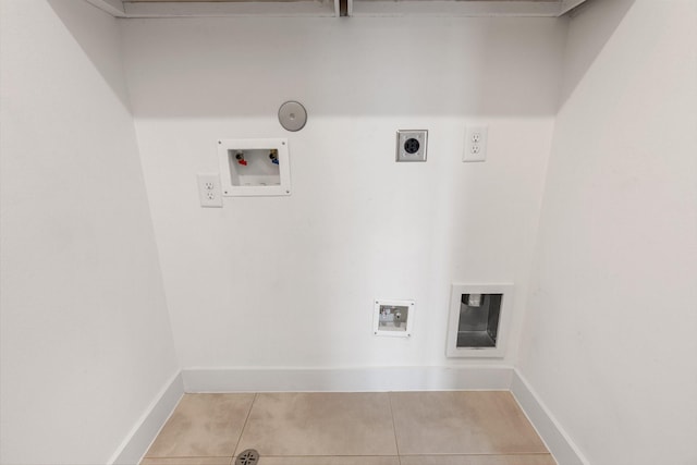 2653 Fountain Key Blvd, Houston, TX 77008 - laundry room featuring hookup for an electric dryer, light tile patterned floors, hookup for a washing machine, baseboards, and hookup for a gas dryer