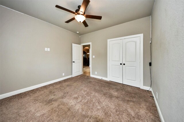 31602 Hummingbird Oak Dr, Hockley, TX 77447 - unfurnished bedroom featuring carpet, baseboards, a closet, and ceiling fan