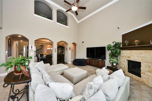 31602 Hummingbird Oak Dr, Hockley, TX 77447 - living area featuring arched walkways, ceiling fan, a fireplace, high vaulted ceiling, and ornamental molding