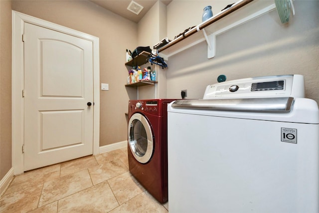 31602 Hummingbird Oak Dr, Hockley, TX 77447 - laundry room featuring washing machine and dryer, baseboards, and light tile patterned floors