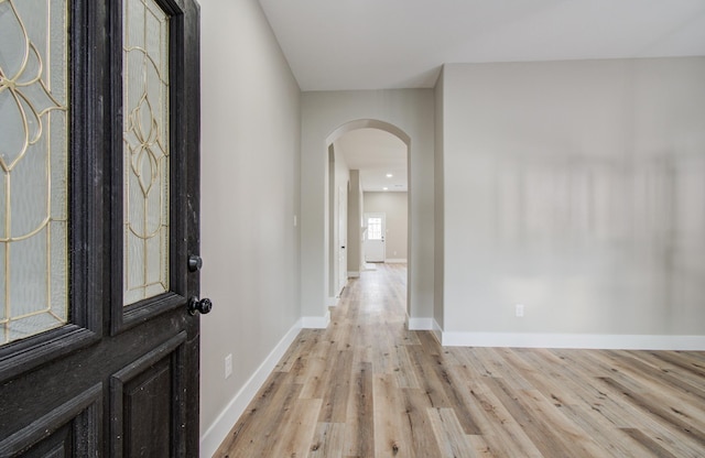 4506 Knights Ct, Baytown, TX 77521 - foyer entrance featuring arched walkways, light wood finished floors, and baseboards