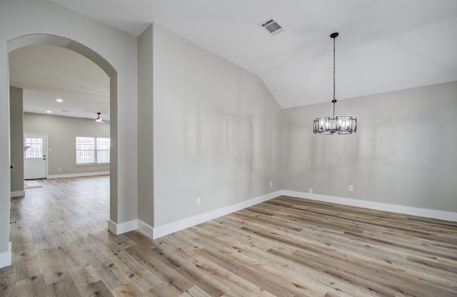 4506 Knights Ct, Baytown, TX 77521 - empty room with arched walkways, wood finished floors, lofted ceiling, ceiling fan, and baseboards