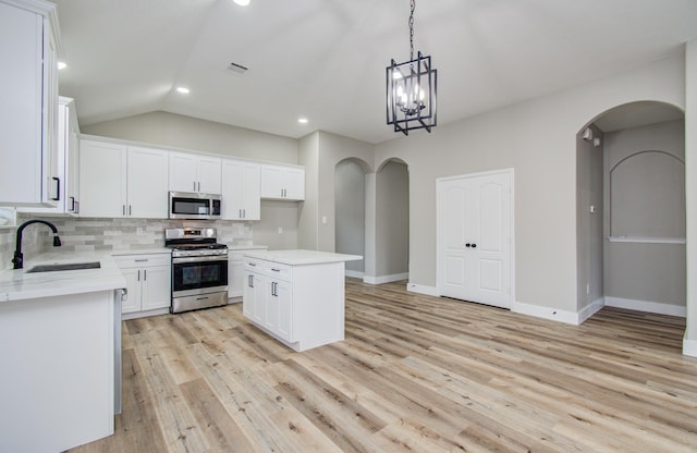 4506 Knights Ct, Baytown, TX 77521 - kitchen with appliances with stainless steel finishes, a sink, arched walkways, decorative backsplash, and recessed lighting