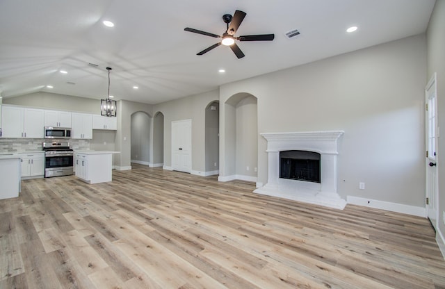 4506 Knights Ct, Baytown, TX 77521 - unfurnished living room featuring a ceiling fan, recessed lighting, a fireplace with raised hearth, light wood finished floors, and baseboards