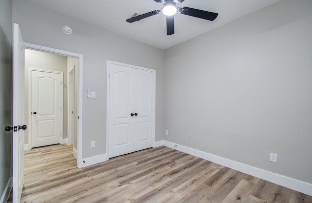 4506 Knights Ct, Baytown, TX 77521 - unfurnished bedroom with light wood-style floors, baseboards, and a closet