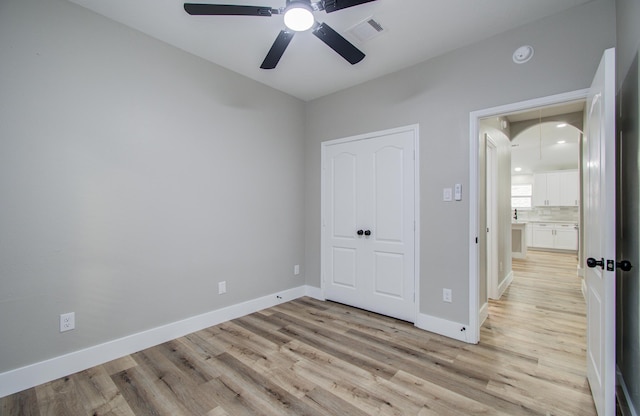 4506 Knights Ct, Baytown, TX 77521 - unfurnished bedroom with attic access, light wood-style flooring, baseboards, and a ceiling fan
