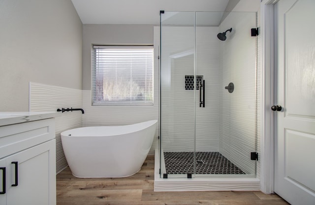 4506 Knights Ct, Baytown, TX 77521 - full bath featuring a soaking tub, a stall shower, vanity, tile walls, and wood finished floors