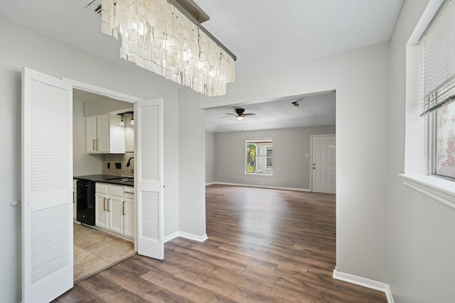 801 Thornwood Dr, Shenandoah, TX 77381 - interior space featuring black dishwasher, dark wood-style floors, white cabinetry, ceiling fan, and dark countertops