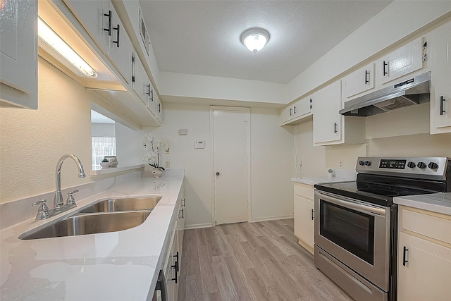 3968 Belle Park Dr, Houston, TX 77072 - kitchen with electric range, under cabinet range hood, a sink, light wood-type flooring, and white cabinets