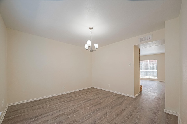 3968 Belle Park Dr, Houston, TX 77072 - spare room with wood finished floors, a chandelier, and baseboards