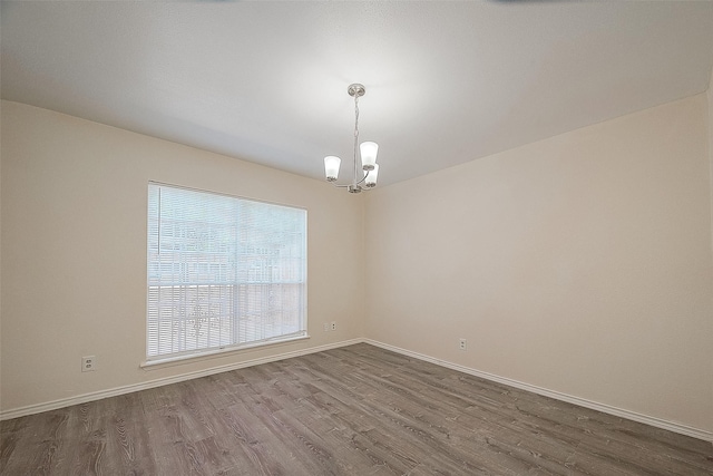 3968 Belle Park Dr, Houston, TX 77072 - empty room with dark wood finished floors, a chandelier, and baseboards